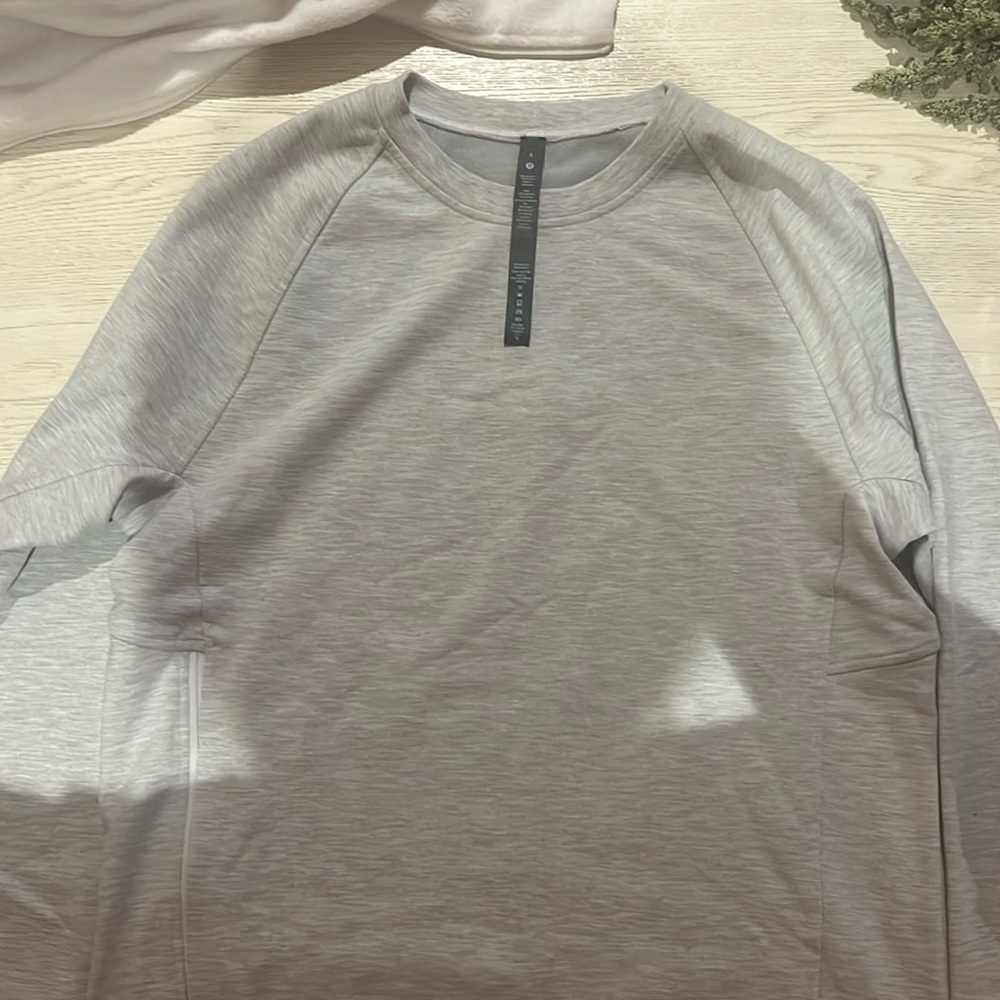 Lululemon (NWOT) never wore size small Heather gray sweatshirt with side zips.